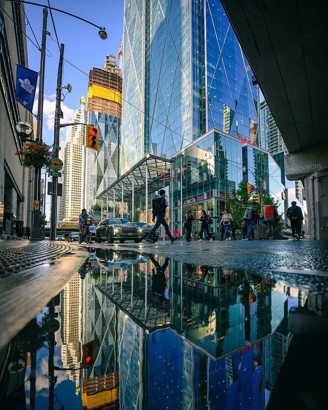 Cityscapes mirrored in puddles