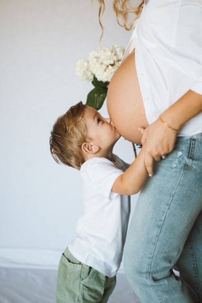 Sibling Kissing the Baby Bump