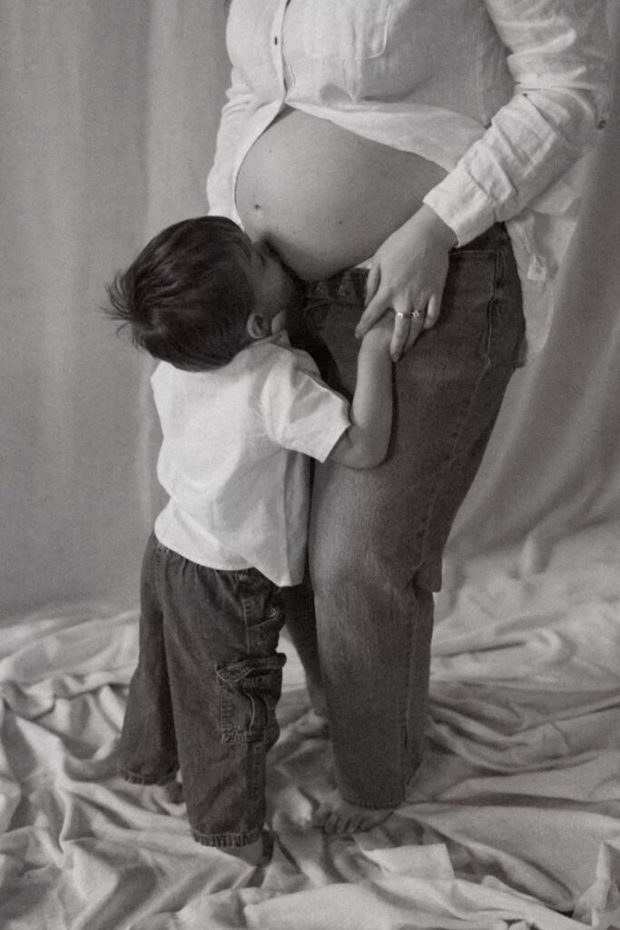 Siblings Whispering to the Bump