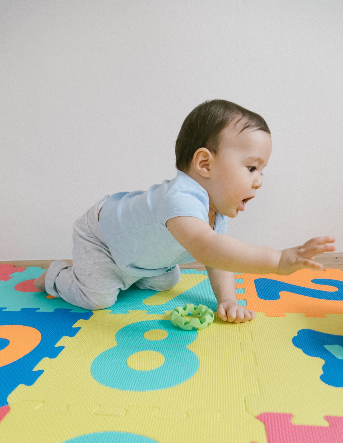 Month 7: Reaching and Rolling Action - baby photography idea